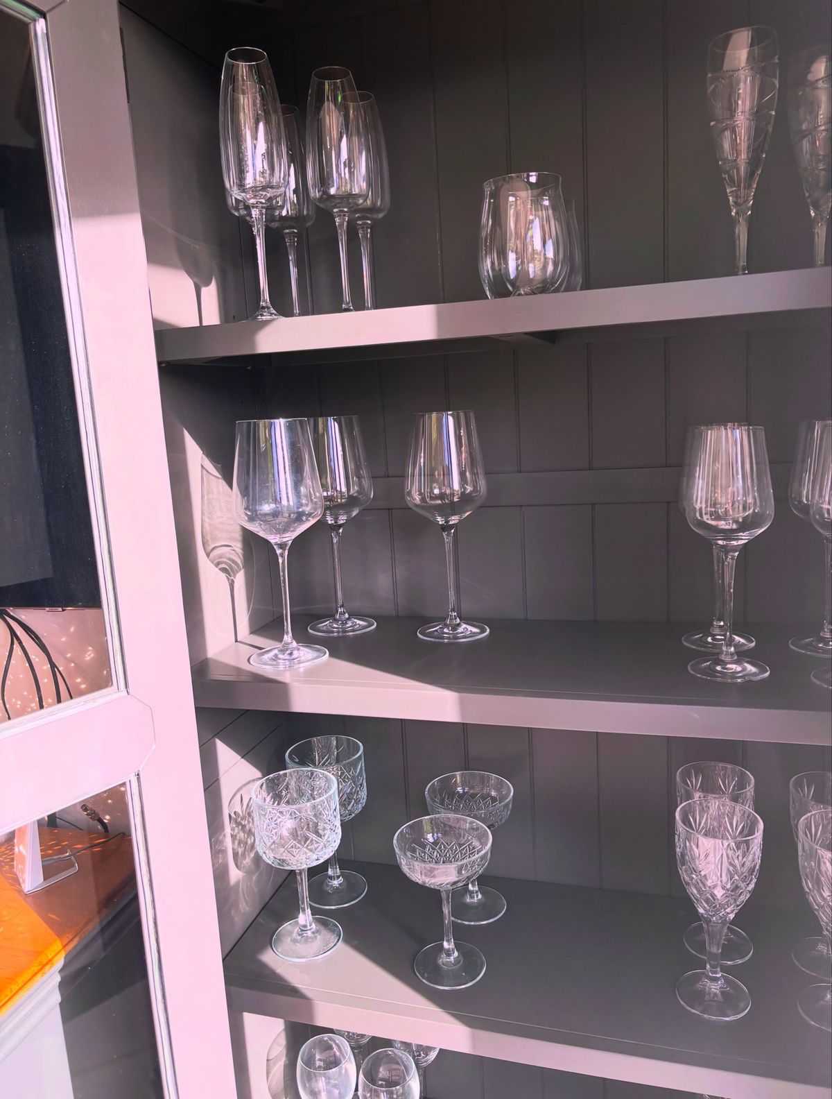 Sparkling glassware on clean cabinet shelves