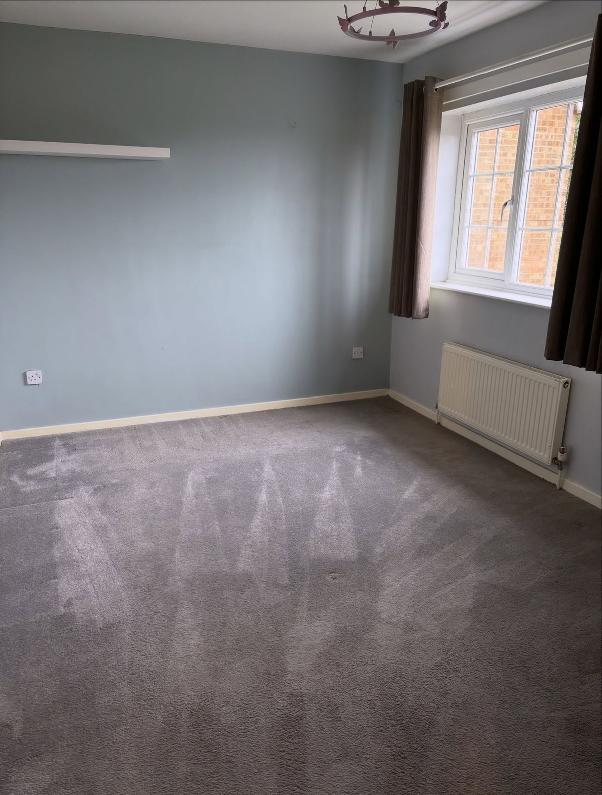 Empty room with fresh vacuum lines in the carpet