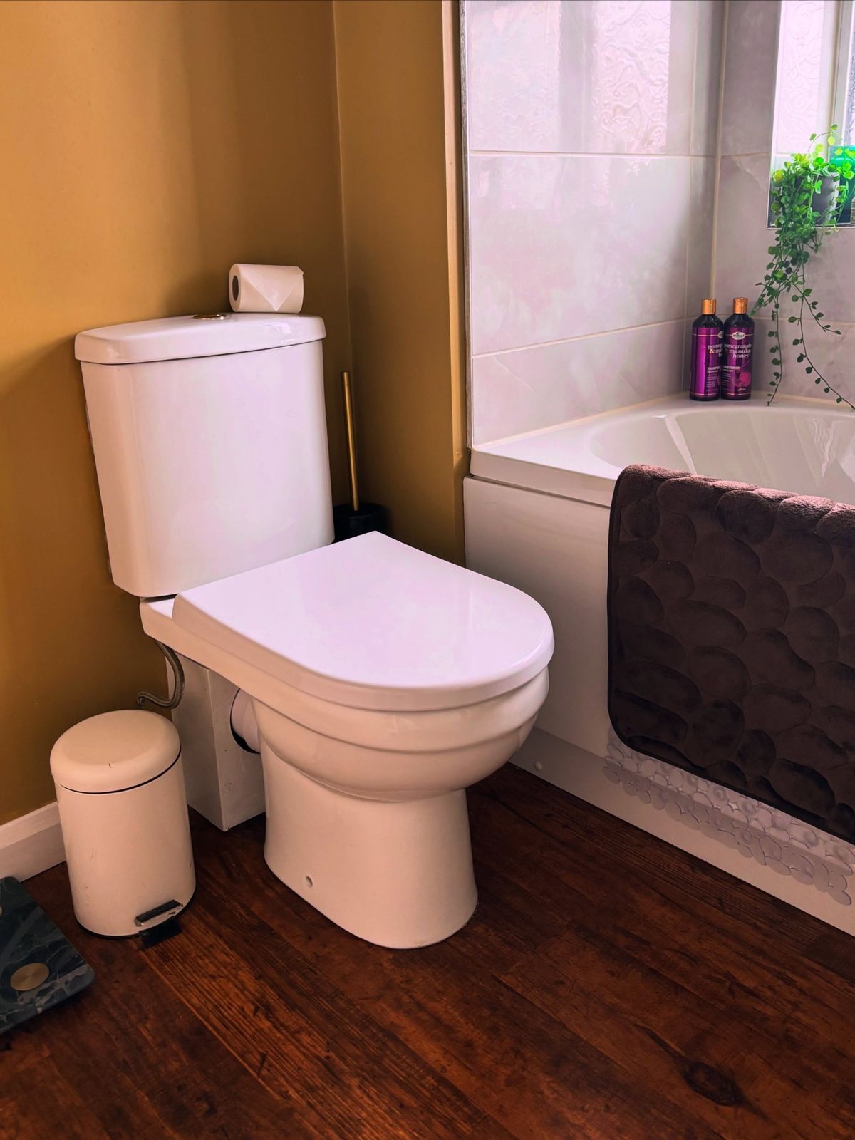 Clean bathroom with toilet and bath